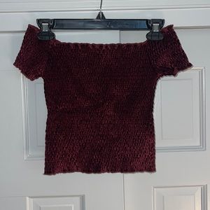 Red velvet scrunched off-the-shoulder top.